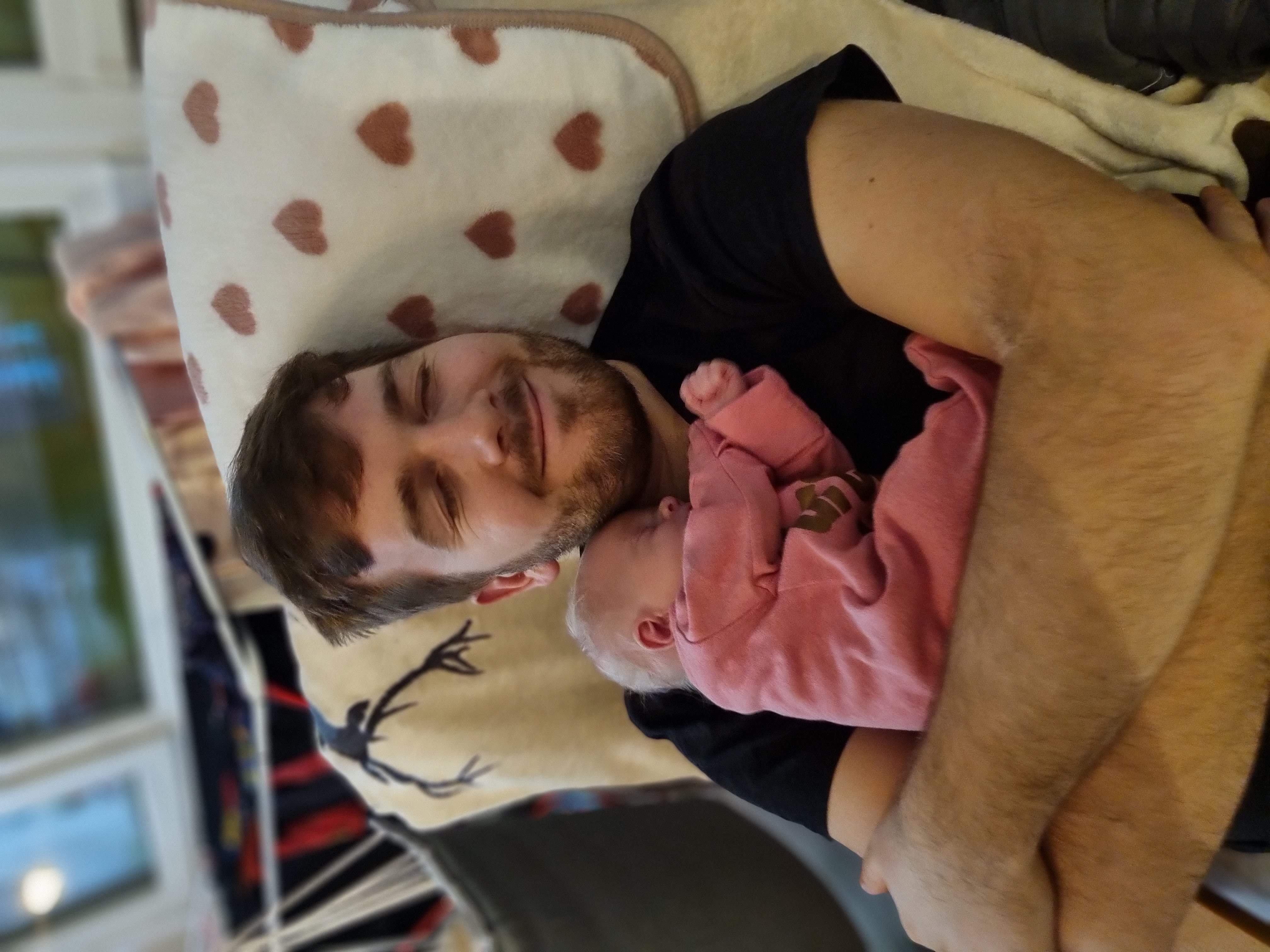 Patrik holding his newborn daughter