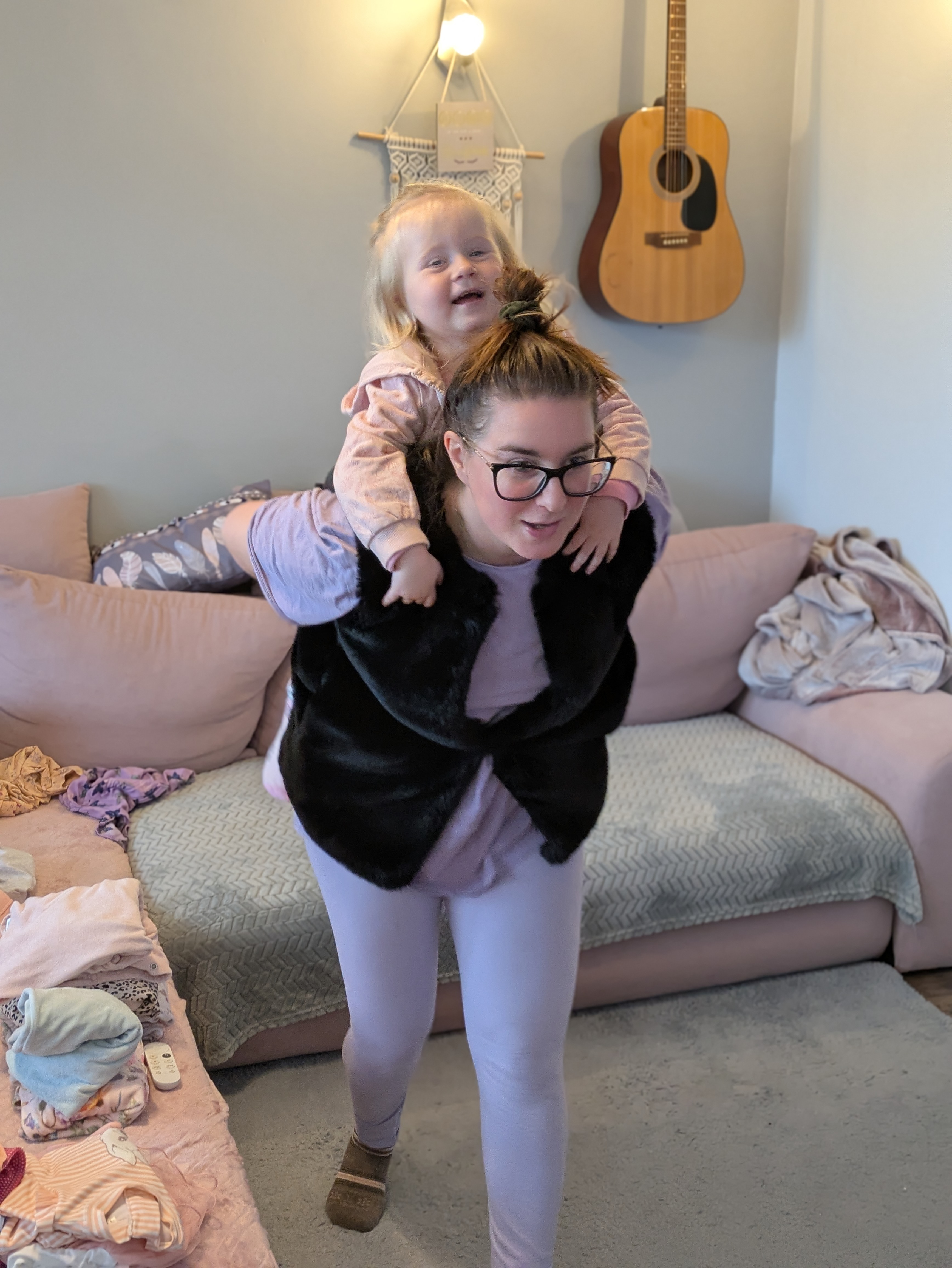 Patrik's wife carrying their daughter on her back